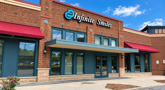 The Infinite Smiles storefront and sign on Medlock Bridge Road